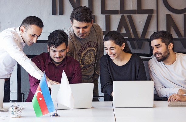 Group smiling and working on Start-Up Visa Canada