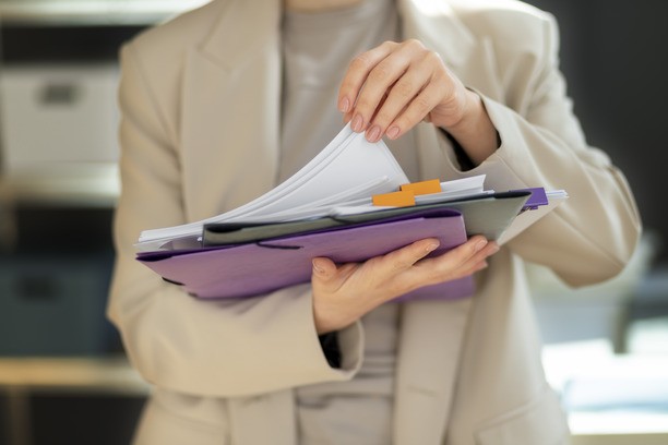 Woman holding documents for Canada Visitor Visa