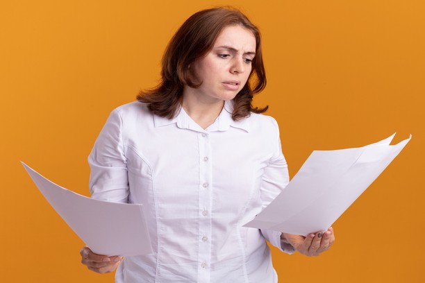 Woman worriedly reviewing important legal documents