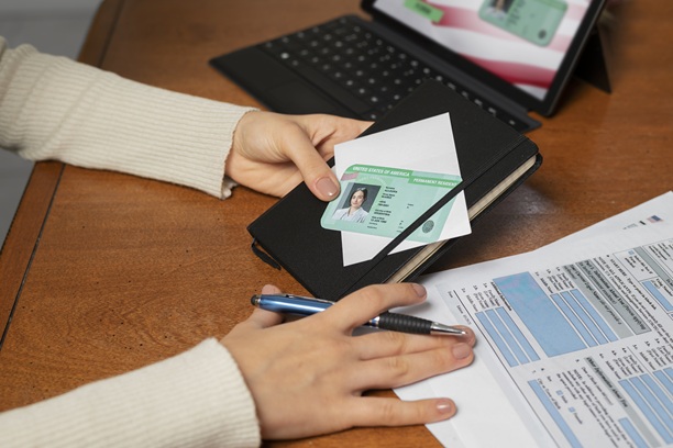 Canadian permanent residence card with documents on desk