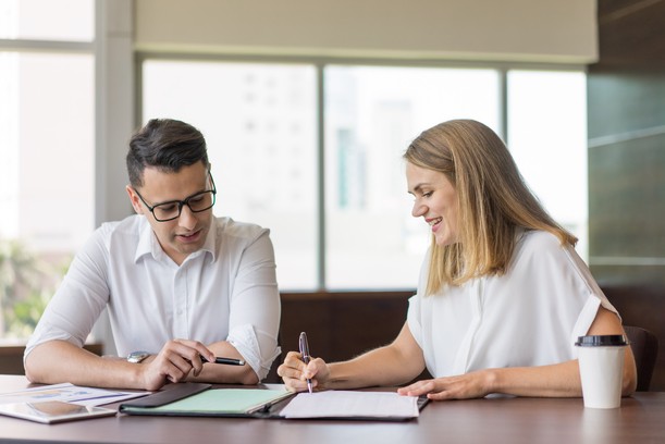Two people reviewing important paperwork together.